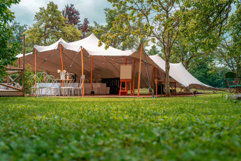 A picture of a stretch tent set-up in a garden, we specialise in stretch tent hire nationwide.